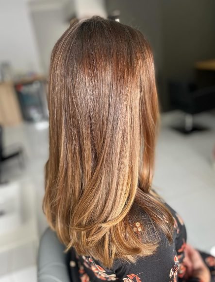 Glossy caramel balayage on sleek straight hair